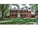 Traditional brick home with symmetrical design, complete with dormer windows and a well-maintained front lawn at 2121 Ponce De Leon Ne Ave, Atlanta, GA 30307