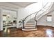 Grand foyer with curved staircase, hardwood floors, and access to the living room at 2121 Ponce De Leon Ne Ave, Atlanta, GA 30307