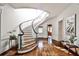 Elegant foyer with a curved staircase, hardwood floors, and abundant natural light, creating a grand entrance at 2121 Ponce De Leon Ne Ave, Atlanta, GA 30307
