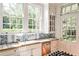 Bright and airy kitchen with stainless appliances, tile counters and backsplash, and outdoor views at 2121 Ponce De Leon Ne Ave, Atlanta, GA 30307