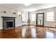 Bright living room with fireplace, hardwood floors, and three windows at 2121 Ponce De Leon Ne Ave, Atlanta, GA 30307