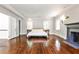 Bright main bedroom featuring hardwood floors, a fireplace, and two windows at 2121 Ponce De Leon Ne Ave, Atlanta, GA 30307