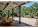 Covered patio with dining table and decorative columns overlooking the backyard and gazebo at 2121 Ponce De Leon Ne Ave, Atlanta, GA 30307