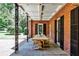 Covered patio featuring a dining table and seating, with brick wall and columns at 2121 Ponce De Leon Ne Ave, Atlanta, GA 30307