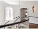 Curved staircase with dark railing and natural light from a window at 2121 Ponce De Leon Ne Ave, Atlanta, GA 30307