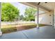 Covered back porch with a view of the well-maintained yard with a white picket fence at 3012 Keeneland Blvd, Mcdonough, GA 30252