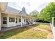 Beautiful backyard features a covered porch with rocking chairs and a white picket fence at 3012 Keeneland Blvd, Mcdonough, GA 30252