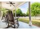Covered back porch with rocking chairs overlooking a private fenced backyard at 3012 Keeneland Blvd, Mcdonough, GA 30252