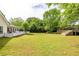 Expansive backyard featuring a white picket fence, deck, and plenty of lawn space for outdoor activities and entertaining at 3012 Keeneland Blvd, Mcdonough, GA 30252