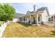 Expansive backyard showcasing a patio, lush lawn, tall trees and a quaint white picket fence at 3012 Keeneland Blvd, Mcdonough, GA 30252