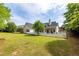 Large backyard with mature trees, a well-maintained lawn, and a charming white picket fence at 3012 Keeneland Blvd, Mcdonough, GA 30252