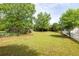 Spacious backyard featuring lush lawn, mature trees, garden beds, and a multi-tiered deck at 3012 Keeneland Blvd, Mcdonough, GA 30252