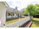 Large backyard with lush grass, mature trees, a patio, and a charming white picket fence at 3012 Keeneland Blvd, Mcdonough, GA 30252