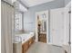 Bright bathroom featuring a soaking tub with glass block window and access to a walk-in closet at 3012 Keeneland Blvd, Mcdonough, GA 30252