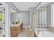Stylish bathroom featuring a bathtub, a glass shower, and double sinks at 3012 Keeneland Blvd, Mcdonough, GA 30252