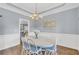 Dining room showcasing a chandelier and wainscoting for an elegant touch at 3012 Keeneland Blvd, Mcdonough, GA 30252