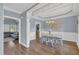 Formal dining room with a chandelier, wainscoting, and hardwood floors at 3012 Keeneland Blvd, Mcdonough, GA 30252