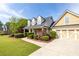 Well maintained home with stone accents, dormer windows, attached two-car garage, and landscaped yard at 3012 Keeneland Blvd, Mcdonough, GA 30252