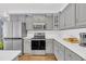 Close-up of stainless steel appliances and gray cabinets in a well-lit kitchen space at 3012 Keeneland Blvd, Mcdonough, GA 30252