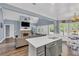 Open-concept kitchen/living room space featuring a fireplace, gray sectional sofa, and stainless appliances at 3012 Keeneland Blvd, Mcdonough, GA 30252
