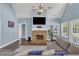 Living room with vaulted ceiling, stone fireplace, hardwood flooring and a comfortable gray sofa at 3012 Keeneland Blvd, Mcdonough, GA 30252