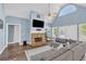 Living room with stone fireplace, vaulted ceilings, hardwood flooring and a neutral color scheme at 3012 Keeneland Blvd, Mcdonough, GA 30252