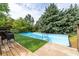 Backyard pool with wooden deck and privacy provided by mature trees at 3012 Keeneland Blvd, Mcdonough, GA 30252