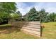 A wooden deck with stairs leads to outdoor entertaining or dining area, surrounded by mature trees at 3012 Keeneland Blvd, Mcdonough, GA 30252