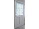 White paneled back door with window panes allowing natural light into the home at 3664 Satellite Ter, Ellenwood, GA 30294
