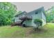 Wide angled view of home's backyard showing elevated deck and grassy yard at 3664 Satellite Ter, Ellenwood, GA 30294