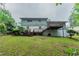 An angled view of backyard of a home with a large deck and grassy yard at 3664 Satellite Ter, Ellenwood, GA 30294