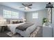 A virtually staged bedroom features a bed, dresser, and two windows at 3664 Satellite Ter, Ellenwood, GA 30294