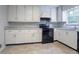 Kitchen featuring black appliances, white cabinets and countertops at 3664 Satellite Ter, Ellenwood, GA 30294
