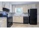 Well-lit kitchen featuring modern black appliances, white cabinets, and neutral countertops at 3664 Satellite Ter, Ellenwood, GA 30294