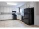 Kitchen with white cabinets, black appliances, and neutral countertops at 3664 Satellite Ter, Ellenwood, GA 30294
