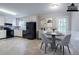 Kitchen featuring appliances, white cabinets, eat in table, and door to back yard at 3664 Satellite Ter, Ellenwood, GA 30294