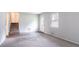 Neutral living room featuring an entry door, a window and staircase to upper level at 3664 Satellite Ter, Ellenwood, GA 30294
