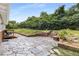 Backyard with stone patio, landscaping, and green lawn at 1619 Folkstone Ne Rd, Brookhaven, GA 30329