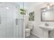 Bathroom with glass-enclosed shower, modern white fixtures, and tile flooring at 1619 Folkstone Ne Rd, Brookhaven, GA 30329