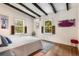 Bedroom featuring hardwood floors, exposed beams, and lots of natural light at 1619 Folkstone Ne Rd, Brookhaven, GA 30329