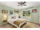 Bright bedroom featuring a cozy bed, wood-paneled walls, and a garden view at 1619 Folkstone Ne Rd, Brookhaven, GA 30329
