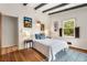 Cozy bedroom with hardwood floors, white walls, and natural light at 1619 Folkstone Ne Rd, Brookhaven, GA 30329