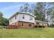Charming two-story home featuring a brick foundation, light siding, and a deck overlooking a spacious lawn at 1619 Folkstone Ne Rd, Brookhaven, GA 30329