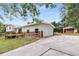 View of home with attached two-car garage and separate outbuilding, driveway and yard at 1619 Folkstone Ne Rd, Brookhaven, GA 30329
