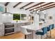 Bright kitchen features an island with seating, modern appliances, and wooden beams at 1619 Folkstone Ne Rd, Brookhaven, GA 30329