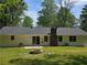Large grass-covered backyard with a fire pit and shed at 2799 Mockingbird Cir, Duluth, GA 30096