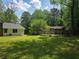 Large grass-covered backyard with a shed in the distance at 2799 Mockingbird Cir, Duluth, GA 30096