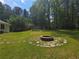 Backyard features lush green grass and a large fire pit at 2799 Mockingbird Cir, Duluth, GA 30096