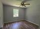 The empty bedroom features wood floors and a ceiling fan at 2799 Mockingbird Cir, Duluth, GA 30096