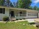 Inviting front entrance with well-kept lawn, covered porch, and attached garage at 2799 Mockingbird Cir, Duluth, GA 30096